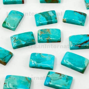 May include: A selection of rectangular turquoise gemstones with a polished finish. The stones display varying shades of blue and green, with brown matrix patterns. The gemstones are arranged on a white surface.