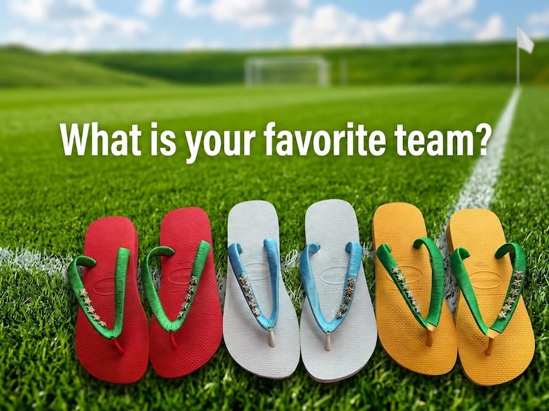 May include: Image features five pairs of colorful flip-flops arranged on a green field with a soccer goal in the background. The flip-flops are red, white, and yellow, with green and blue straps. Text reads: "What is your favorite team?"