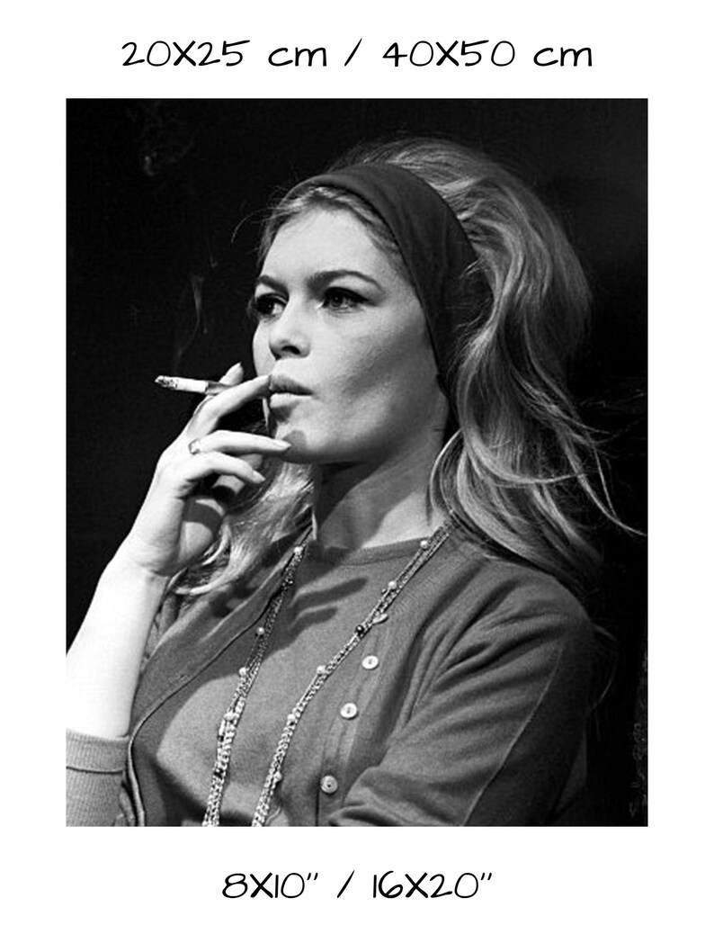 May include: Black and white photograph of a woman smoking a cigarette. She wears a dark headband, a button-down sweater, and a long necklace. The image includes the text "8X10" / 16X20" and "20X25 cm / 40X50 cm".