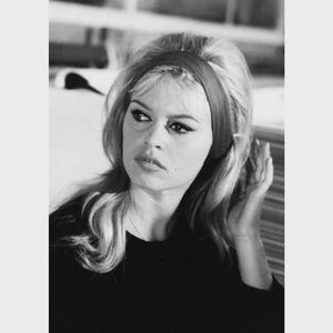May include: Black and white portrait of a woman with blonde hair, wearing a dark top and a headband. The image is available in 4x6", 8x12", and 16x24" sizes.