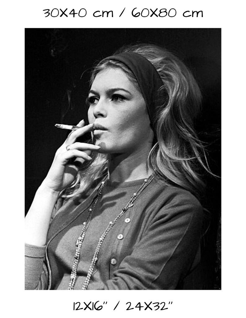May include: Black and white photograph of a woman with long blonde hair wearing a dark headband, a cardigan, and a necklace. She is smoking a cigarette. The image includes the text "30x40 cm / 60x80 cm" and "12x16" / 24x32".