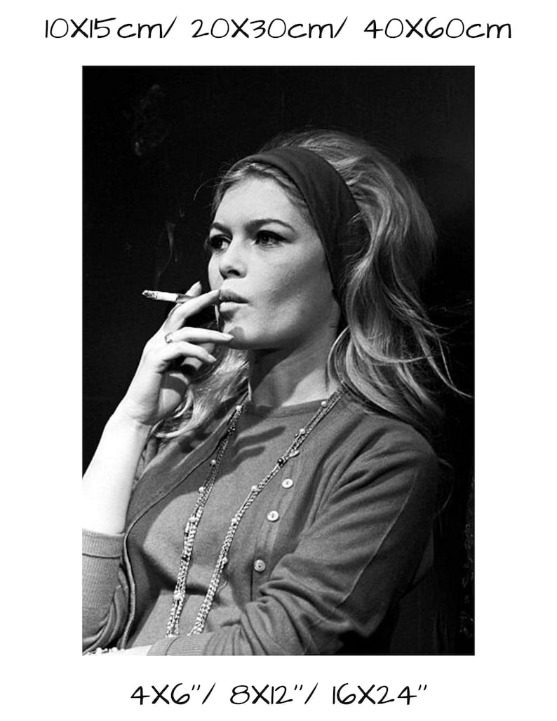 May include: Black and white photograph of a woman smoking a cigarette. She wears a dark headband, a button-down cardigan, and a long necklace. The image includes size options: 4x6", 8x12", and 16x24".