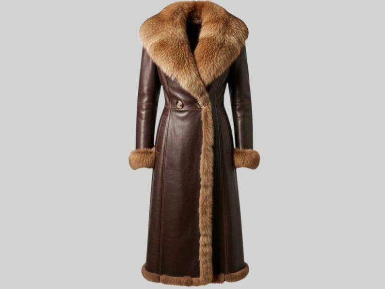 May include: A long, dark brown leather coat with a fur collar and trim. The coat features a double-breasted design with a button closure and fur cuffs. The fur is a lighter brown color, creating a contrast with the darker leather.