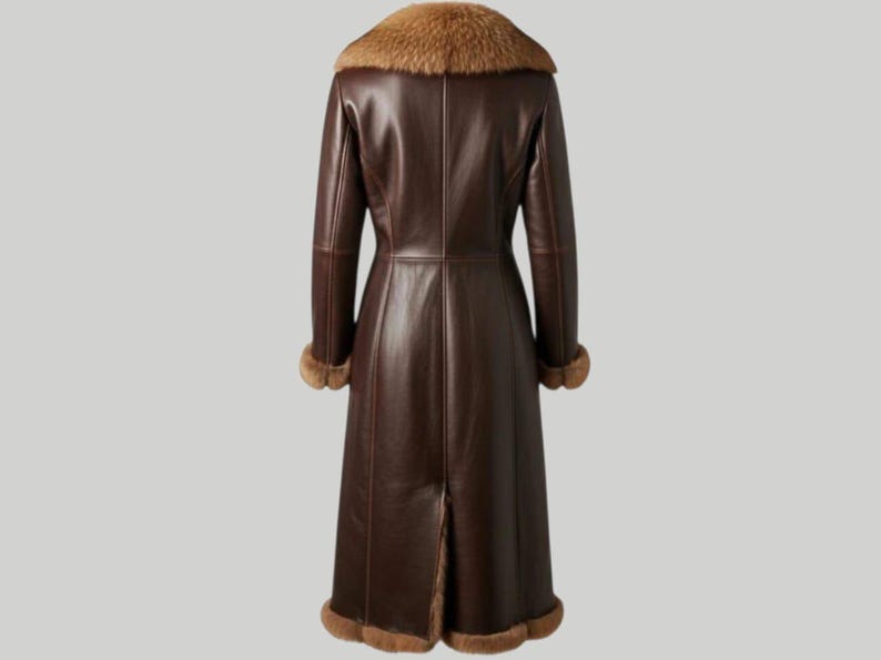 May include: A long, dark brown leather coat with a fur collar and cuffs. The coat has a classic design, reaching to the ankles, and is viewed from the back. The fur trim is a lighter brown color, adding a touch of luxury to the outerwear.