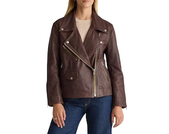 May include: A brown leather jacket with a classic asymmetrical zip closure, featuring a notched collar and multiple zippered pockets. The jacket has a tailored fit and is worn with blue jeans.