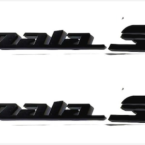 May include: Two black Impala SS emblems, each measuring 14 inches by 1.5 inches. The emblems feature the word "Impala" in a stylized font, followed by "SS". The emblems are displayed against a white background.
