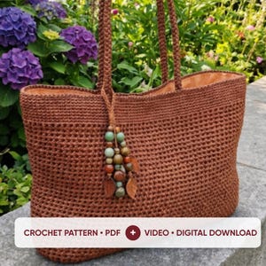 May include: A brown crochet tote bag with two matching handles and a decorative tassel featuring green, brown, and tan beads along with two small brown leaf-shaped charms. The text CROCHET PATTERN • PDF + VIDEO • DIGITAL DOWNLOAD is visible.
