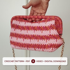 May include: A rectangular crochet handbag featuring horizontal stripes in shades of light pink, bright pink, and orange. The bag has a rigid, wrapped top handle and a gold-tone metal chain strap. Text at the bottom reads: CROCHET PATTERN • PDF + VIDEO • DIGITAL DOWNLOAD.