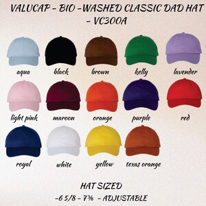 May include: A display of Valucap bio-washed classic dad hats in various colors, including aqua, black, brown, kelly green, and lavender. Additional colors are light pink, maroon, orange, purple, red, royal blue, white, yellow, and texas orange. The hats are adjustable and come in sizes 6 5/8 - 7 3/8.
