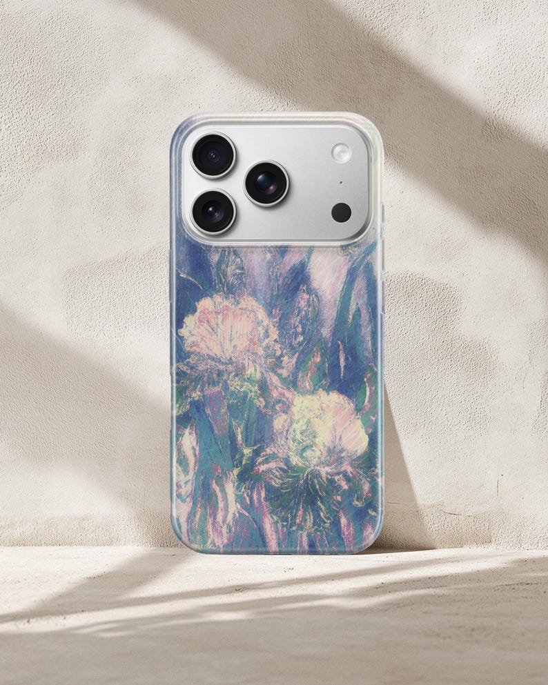 May include: Clear phone case with a floral design in shades of blue, purple, and pink. The case features a clear border and a camera cutout. The floral pattern appears to be an impressionistic painting of irises.