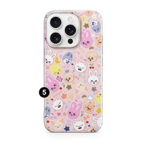 May include: A phone case with a pink background covered in cartoon animal characters, hearts, stars, and rainbows. The case has a clear border and a camera cutout. Text includes "cute!", "baby", and "tiny".