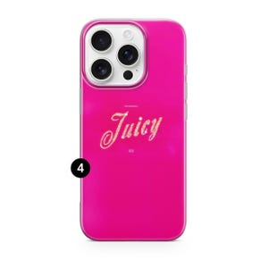 May include: A bright pink phone case with a clear border. The case features the word "Juicy" in a glittery, cursive font. The phone case has a camera module with three lenses and a flash.
