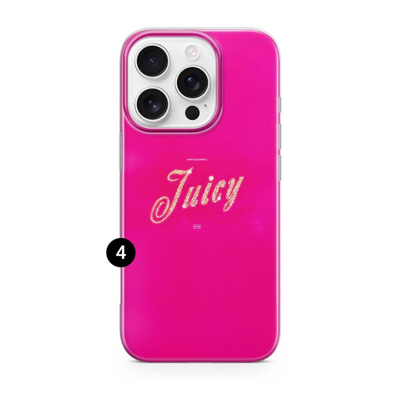 May include: A bright pink phone case with a clear border. The case features the word "Juicy" in a glittery, cursive font. The phone case has a camera module with three lenses and a flash.