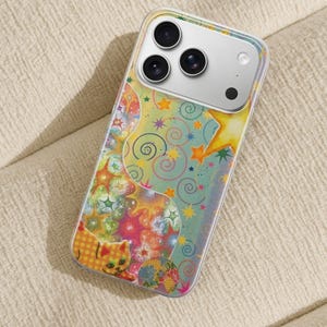 May include: A clear phone case with a colorful, whimsical design. The case features a pattern of stars, swirls, and a cartoon cat in shades of yellow, orange, pink, and blue. The phone's camera lenses are visible.