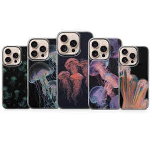 May include: A collection of five phone cases featuring vibrant jellyfish designs. The cases showcase various jellyfish in shades of purple, orange, and green against a black background. The cases are designed for a smartphone.