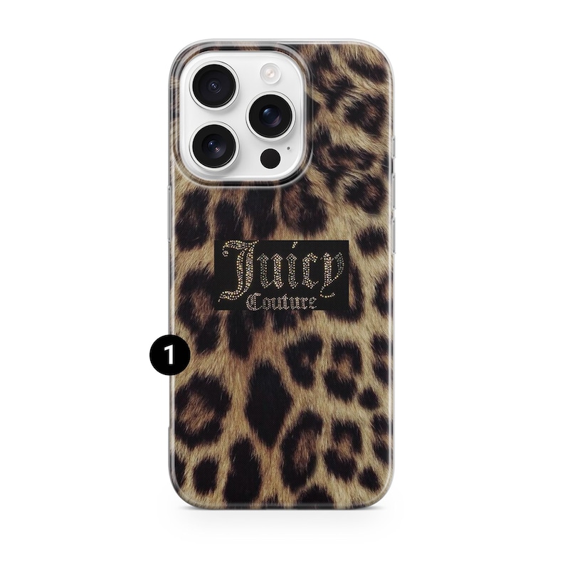 May include: A phone case with a leopard print design. The case features the text "Juicy Couture" in a black rectangle with a rhinestone-like effect. The case is designed to fit a smartphone with multiple camera lenses.