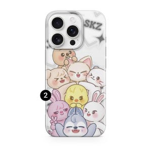 May include: Clear phone case featuring a cartoon illustration of several cute animal characters in various colors. The text "SKZ" is visible at the top. The case is designed to fit a smartphone.