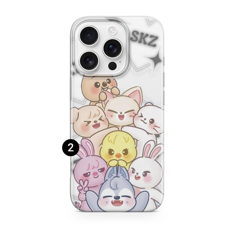 May include: Clear phone case featuring a cartoon illustration of several cute animal characters in various colors. The text "SKZ" is visible at the top. The case is designed to fit a smartphone.