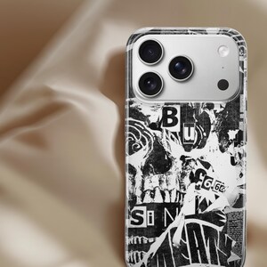 May include: A clear phone case with a black and white collage design. The design features torn paper with text and images, including the letters "Si" and "B". The phone case has a silver camera module.