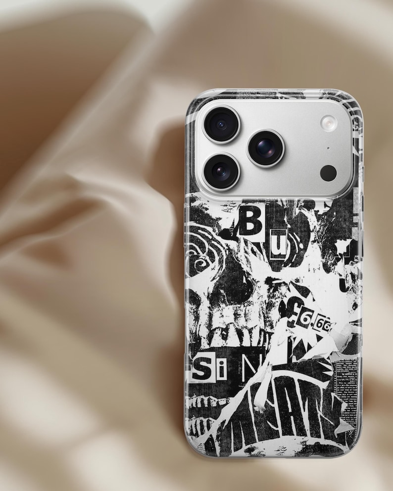 May include: A clear phone case with a black and white collage design. The design features torn paper with text and images, including the letters "Si" and "B". The phone case has a silver camera module.