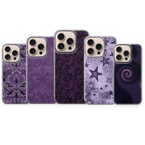 May include: Five phone cases with various purple designs. The cases feature patterns including lace, stars, swirls, and a gothic bat motif. Each case has a clear border around the camera.