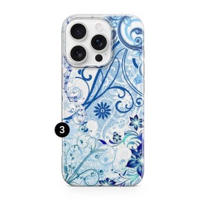May include: A clear phone case with a blue floral design. The case features a pattern of swirling vines, flowers, and leaves in shades of blue and white. The phone case has a camera cutout and the number "3" in a black circle.