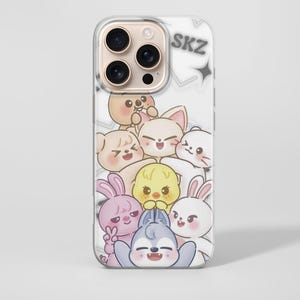 May include: Clear phone case featuring a cartoon illustration of several cute animal characters in various colors. The word "SKZ" is printed in gray at the top. The case is designed to fit a smartphone.