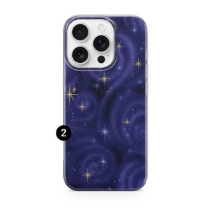 May include: A phone case with a dark blue swirling galaxy design. The case features gold star accents and a clear border. The number "2" is printed in white on the lower left corner of the case.
