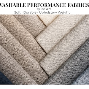 May include: Close-up of several fabric swatches in various neutral colors, including beige, gray, and blue. The image features the text "WASHABLE PERFORMANCE FABRICS" and "Soft • Durable • Upholstery Weight". The fabrics have a textured appearance.