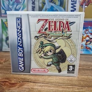 May include: A Game Boy Advance game cartridge for "The Legend of Zelda: The Minish Cap." The cover art features a cartoon illustration of Link, the main character, in a green tunic. The game case is in a clear plastic case with the Nintendo logo.