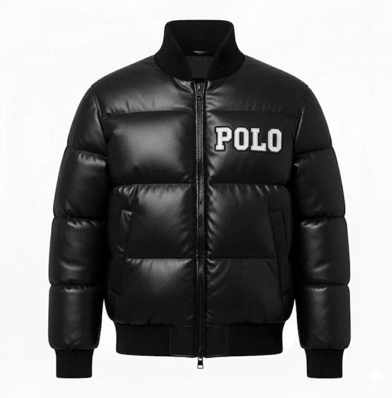 May include: Black puffer jacket with a zip closure, featuring the white word "POLO" on the chest. The jacket has a ribbed collar, cuffs, and hem. A stylish outerwear piece.