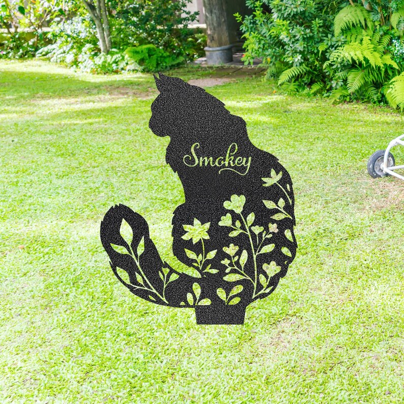 May include: A black metal cat silhouette garden stake with floral cutouts. The cat's name, "Smokey," is scripted across the body. The stake is designed to be placed in a garden or yard, adding a decorative touch.
