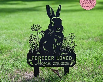 May include: Black metal garden stake featuring a rabbit silhouette amidst floral accents. The sign reads "FOREVER LOVED Mozart 2010-2025". The stake is designed for outdoor use, suitable for memorializing a pet.