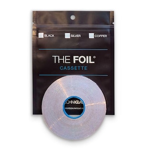 May include: A silver foil cassette with a blue center is displayed in front of a black package. The package has the words "THE FOIL CASSETTE" printed on it, along with the color options: black, silver, and copper.