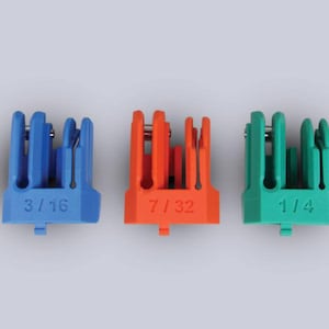 May include: Three plastic tools in blue, orange, and green. Each tool has a series of vertical slots and a measurement printed on the base: 3/16, 7/32, and 1/4. The tools are designed for a specific purpose.