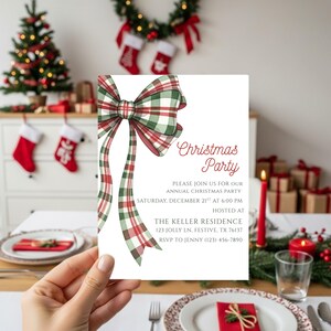May include: A Christmas party invitation with a red and green plaid bow design. The invitation, held by a hand, includes the text "Christmas Party" and event details such as the date, time, and address for the event.