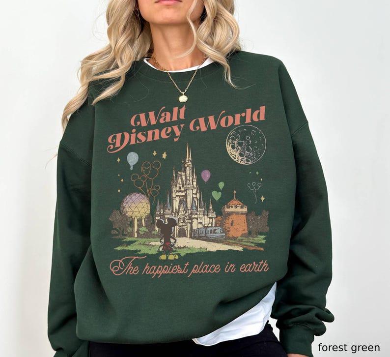 May include: Forest green sweatshirt with a vintage-style Walt Disney World graphic. The design includes the castle, Mickey Mouse, balloons, and the phrase "The happiest place on earth" in a retro font.
