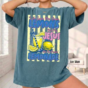 May include: Ice blue t-shirt with a graphic of a lemonade drink, lemons, and the text "Life Gave Me Some Lemons But My Jesus He Be Makin' Lemonade". The design features yellow and pink text.