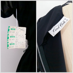 May include: Black dress with a zipper and a white tag that says "Carol Cook".