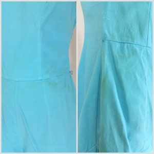 May include: A light blue sleeveless dress with a simple design. The dress has a straight skirt and a fitted bodice.