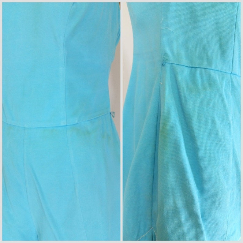 May include: A light blue sleeveless dress with a simple design. The dress has a straight skirt and a fitted bodice.