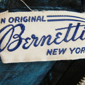 May include: A white label with blue embroidered text that reads "An Original Bernetti New York" with a registered trademark symbol.