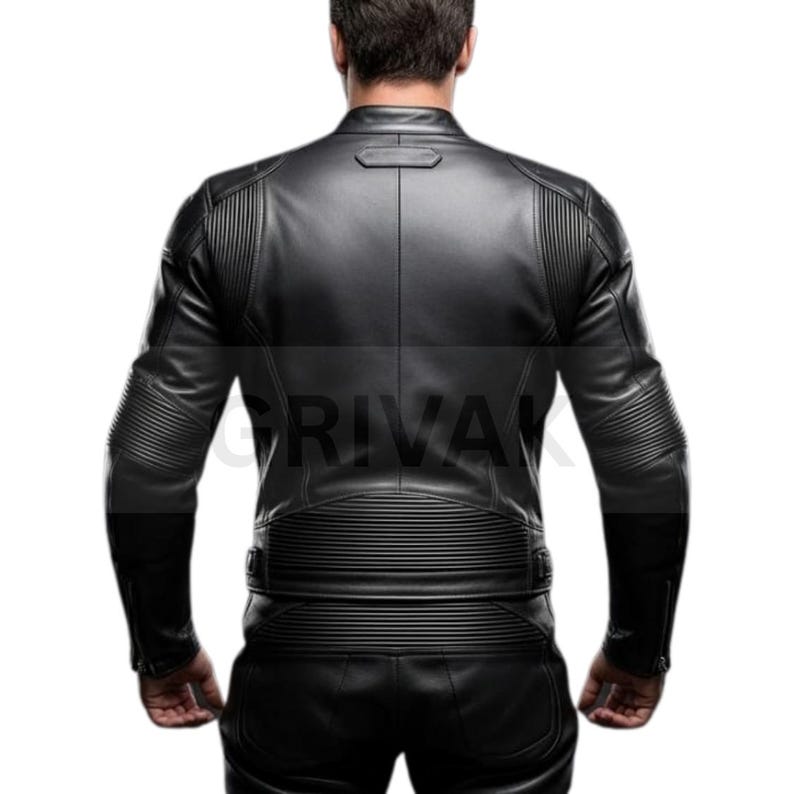 May include: Black leather jacket with ribbed detailing on the shoulders and sleeves. The jacket has a stand-up collar and a zipper closure. The back of the jacket features horizontal and vertical ribbed accents. The jacket is part of a leather outfit.
