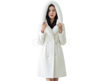 May include: A long, white coat with a large, fur-lined hood. The coat has a cinched waist and a tailored fit. The model is wearing the coat against a white background. The coat is a winter outerwear garment.