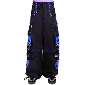 May include: Black pants with blue stitching and skull accents. The pants feature multiple pockets, chains, and metal hardware. The design includes blue skull graphics and a drawstring waist. The pants are worn with black shoes.