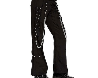 May include: Black pants with silver chain and lace-up details. The pants have a flared leg and are styled with platform shoes. The pants feature grommets and a belt loop.