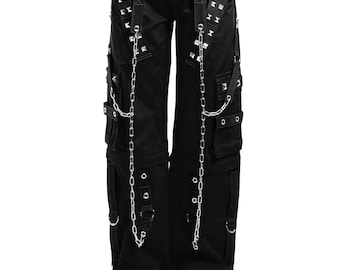 May include: Black cargo pants with multiple pockets, silver chain accents, and studded details. The pants feature adjustable straps, metal rings, and a drawstring waist. The pants are worn with black platform shoes.