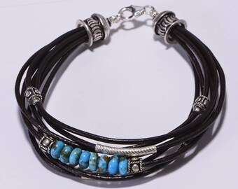 May include: A brown leather bracelet with silver beads and turquoise stones.