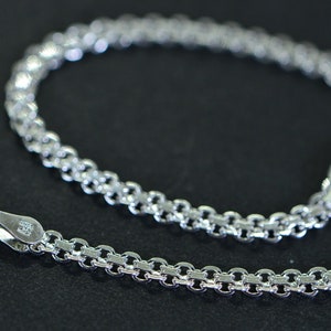 May include: A silver chain bracelet with a lobster clasp closure.