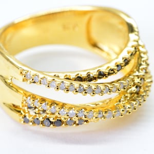 May include: Gold ring with three bands, each set with a row of small clear and black diamonds.